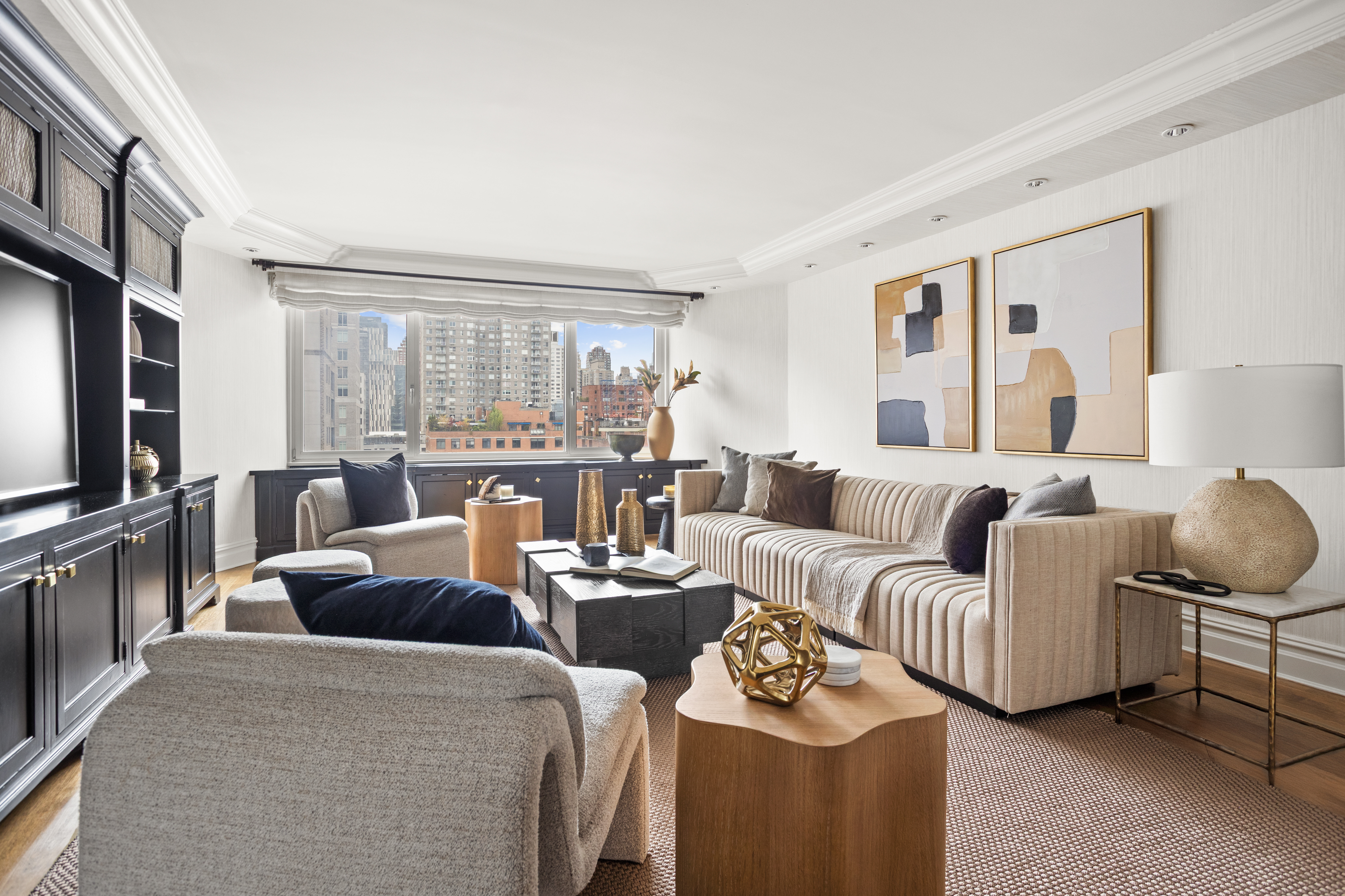 60 East End Avenue, Unit 12C Manhattan, NY 10028 - Photo 2 of 27 a living room with furniture and a flat screen tv