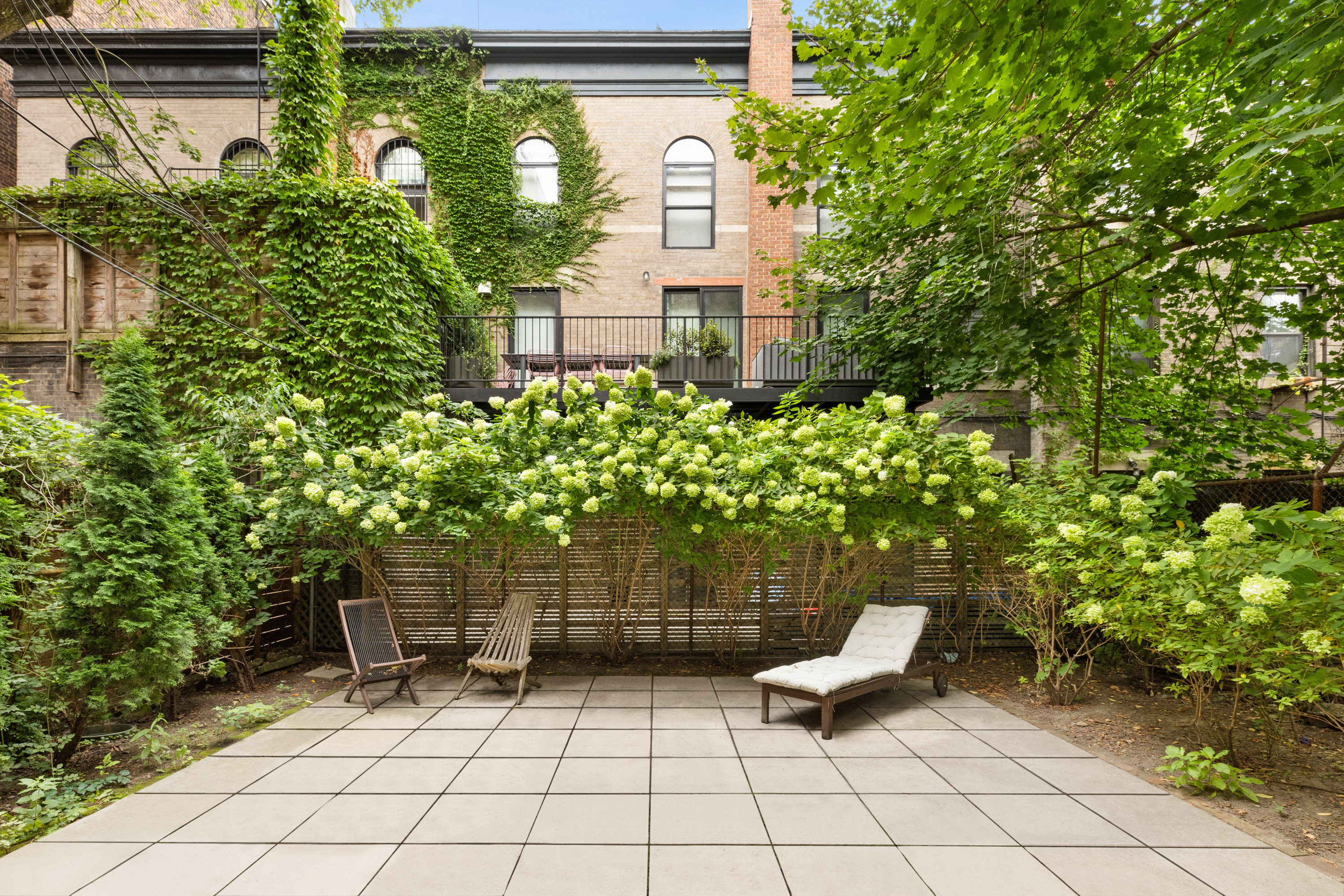 184 Clinton Avenue, Unit 4A Brooklyn, NY 11205 - Photo 8 of 9 a view of a chairs and table in a backyard