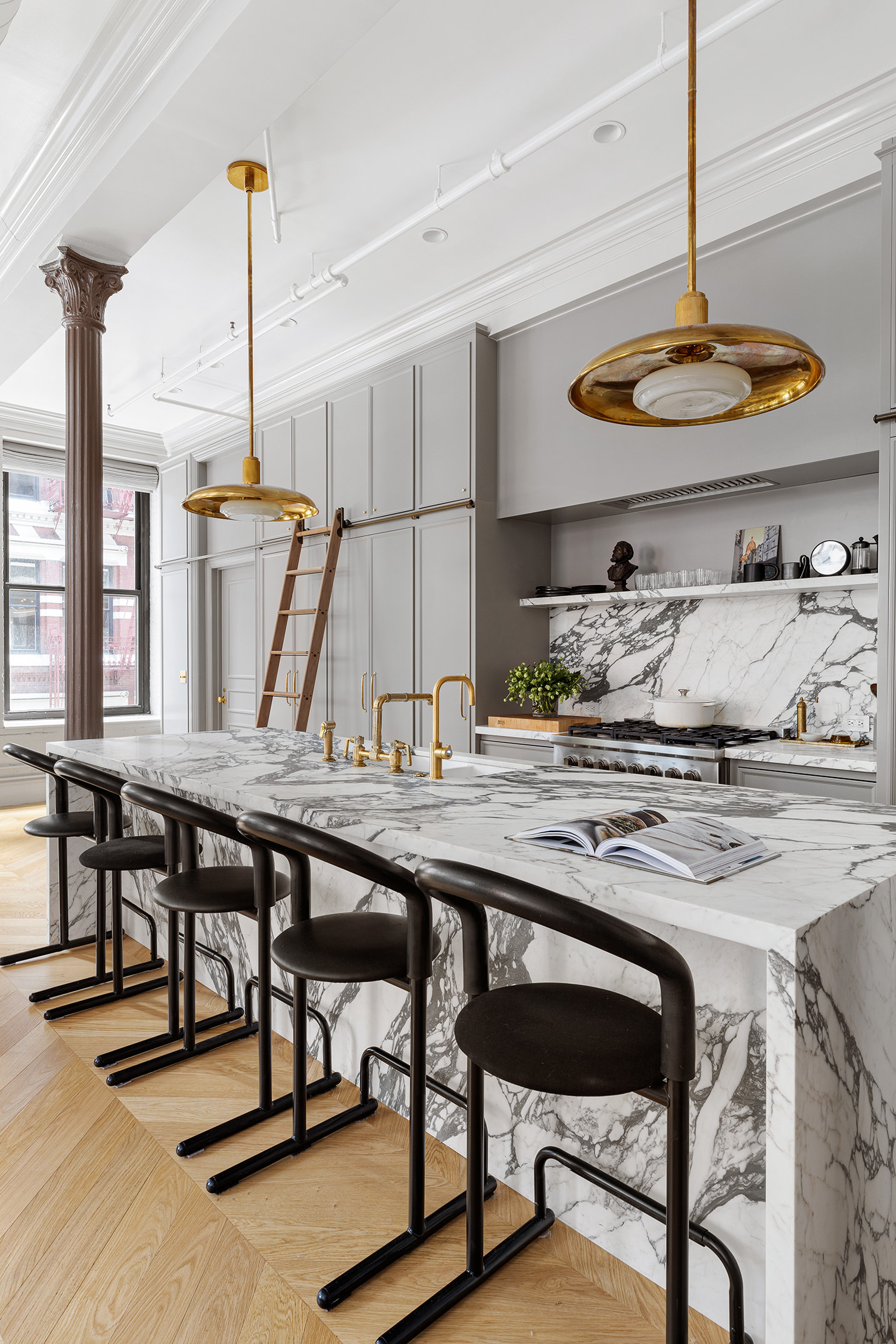 35 Mercer Street, Unit 3E Manhattan, NY 10013 - Photo 9 of 21 a kitchen with stainless steel appliances granite countertop a table chairs stove and cabinets