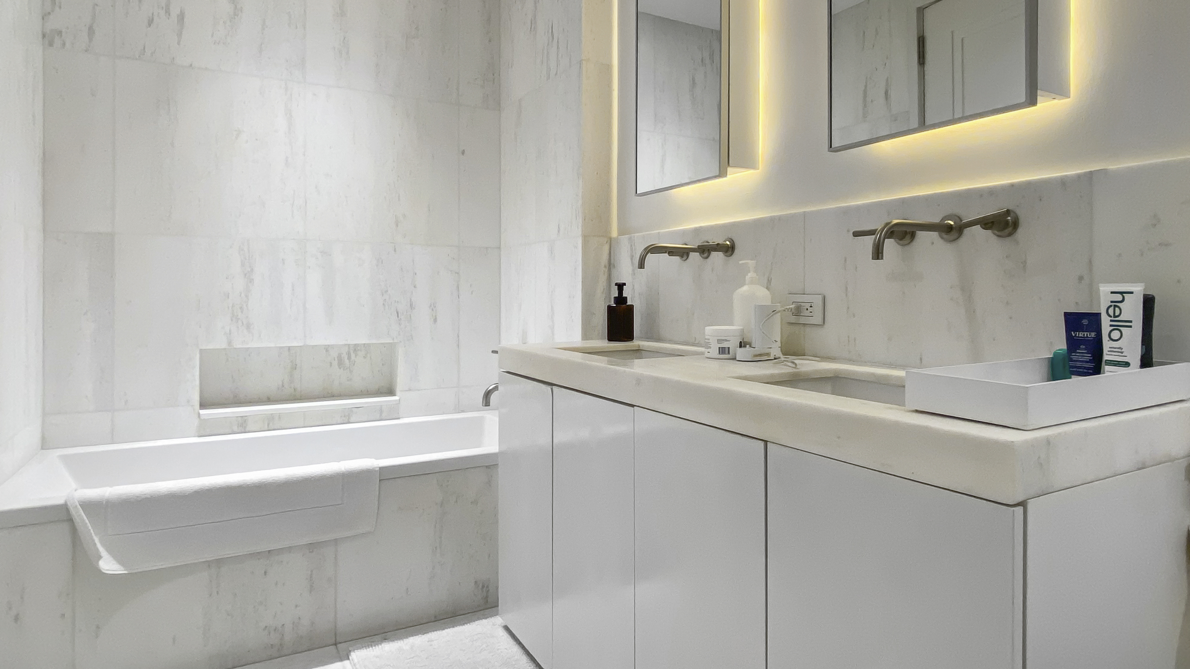 101 Wall Street, Unit 12C Manhattan, NY 10005 - Photo 9 of 18 a bathroom with a sink and a mirror