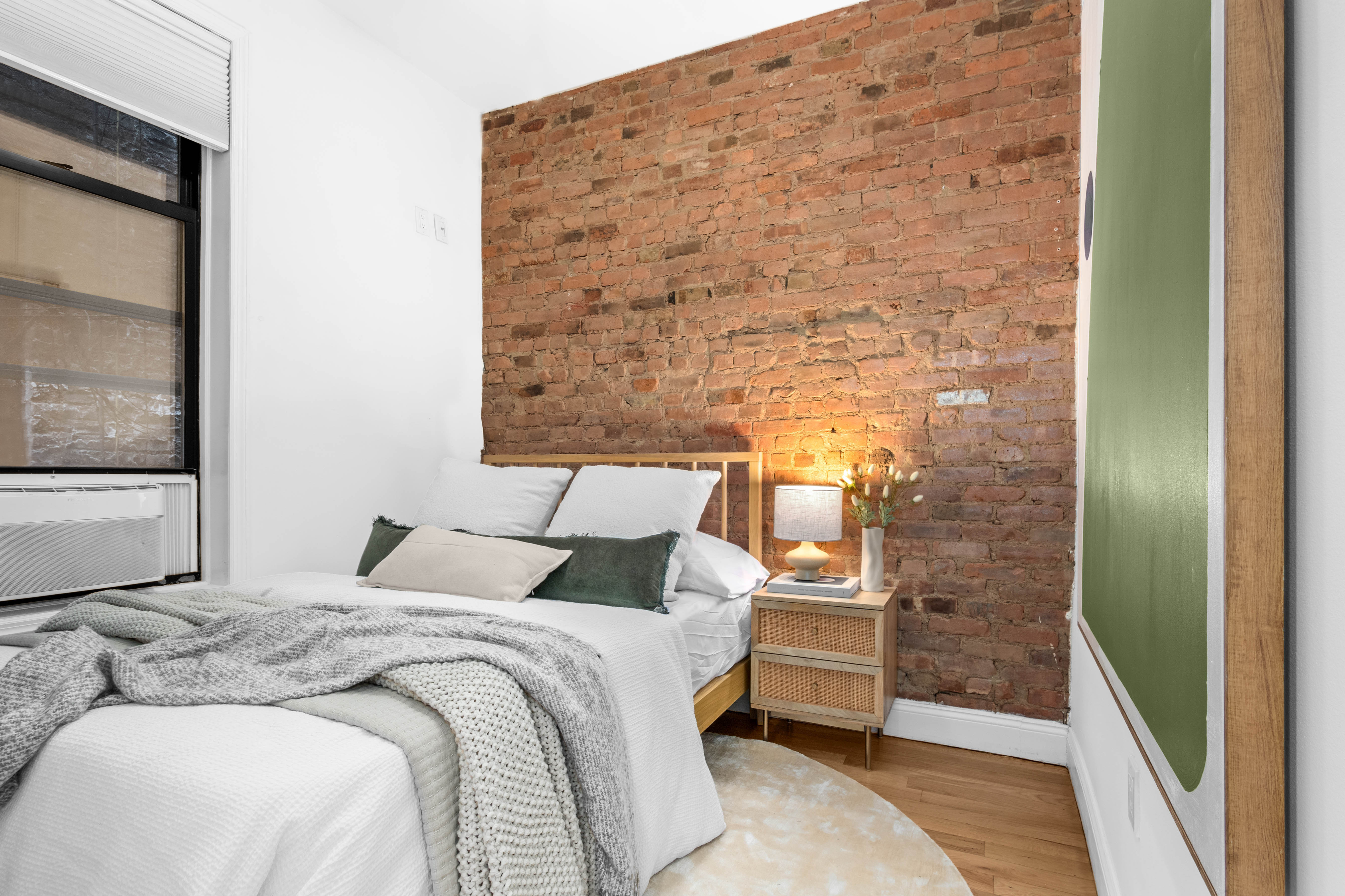 131 Thompson Street, Unit 6F Manhattan, NY 10012 - Photo 5 of 9 a bedroom with a bed and a painting on the wall