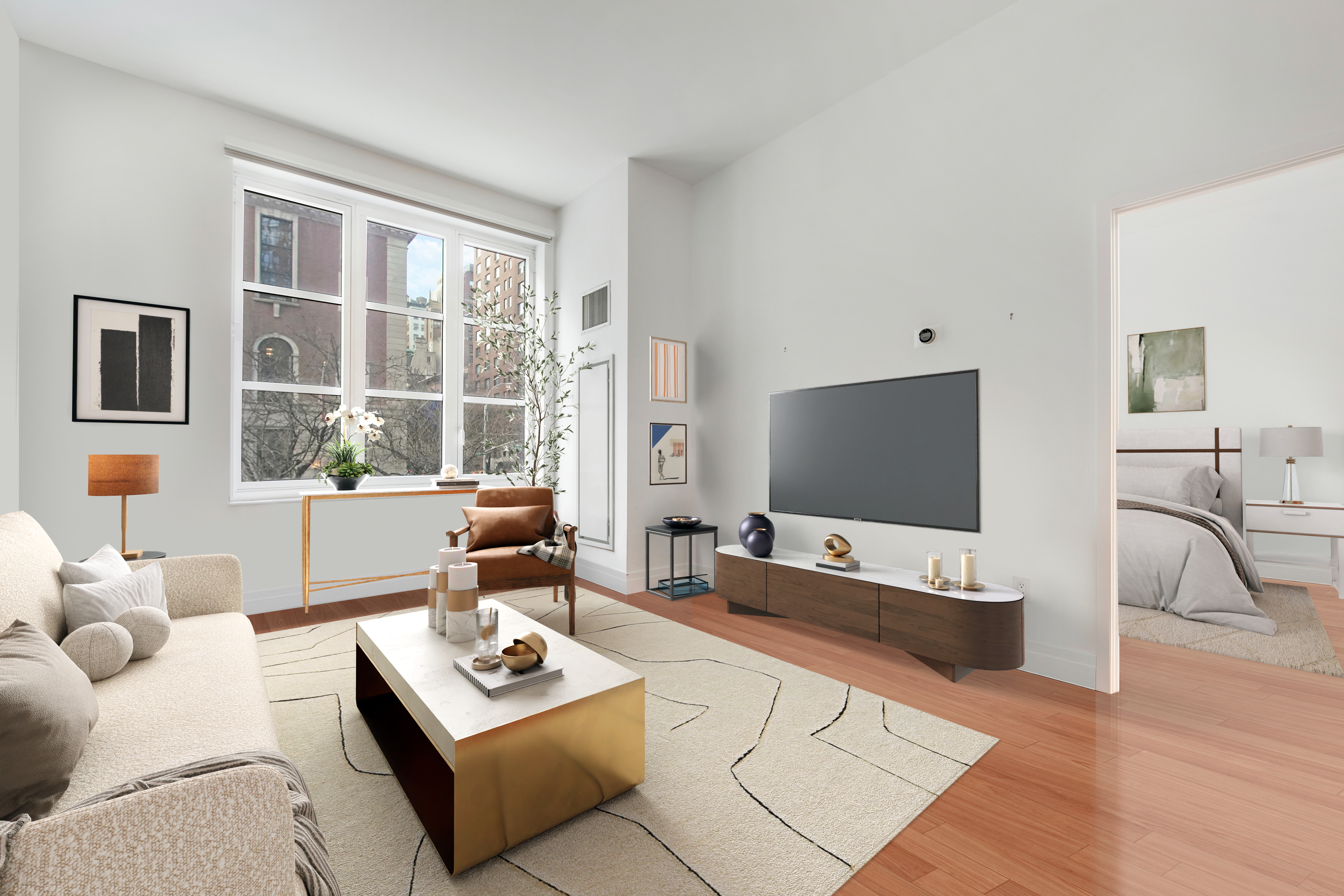 a living room with furniture and a flat screen tv with kitchen view