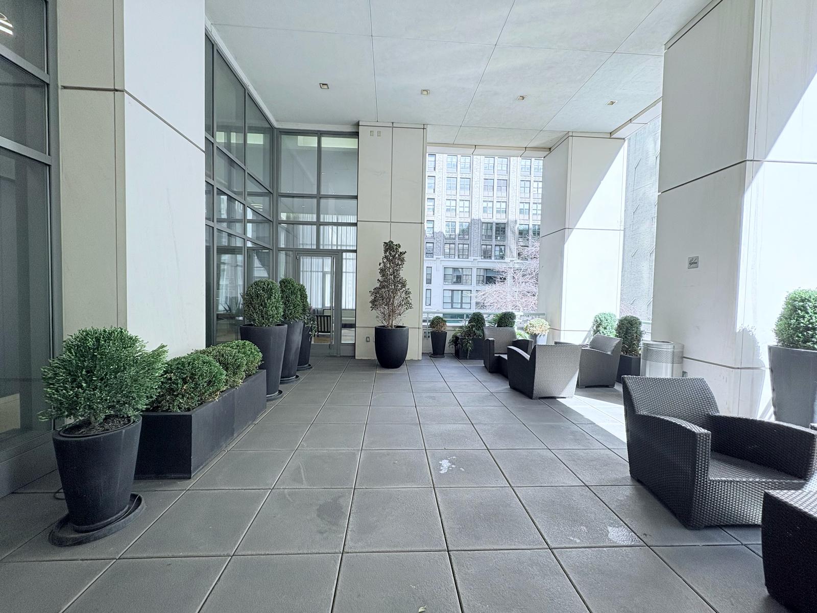 325 5th Avenue, Unit 14E Manhattan, NY 10016 - Photo 14 of 19 a lobby with furniture and potted plant