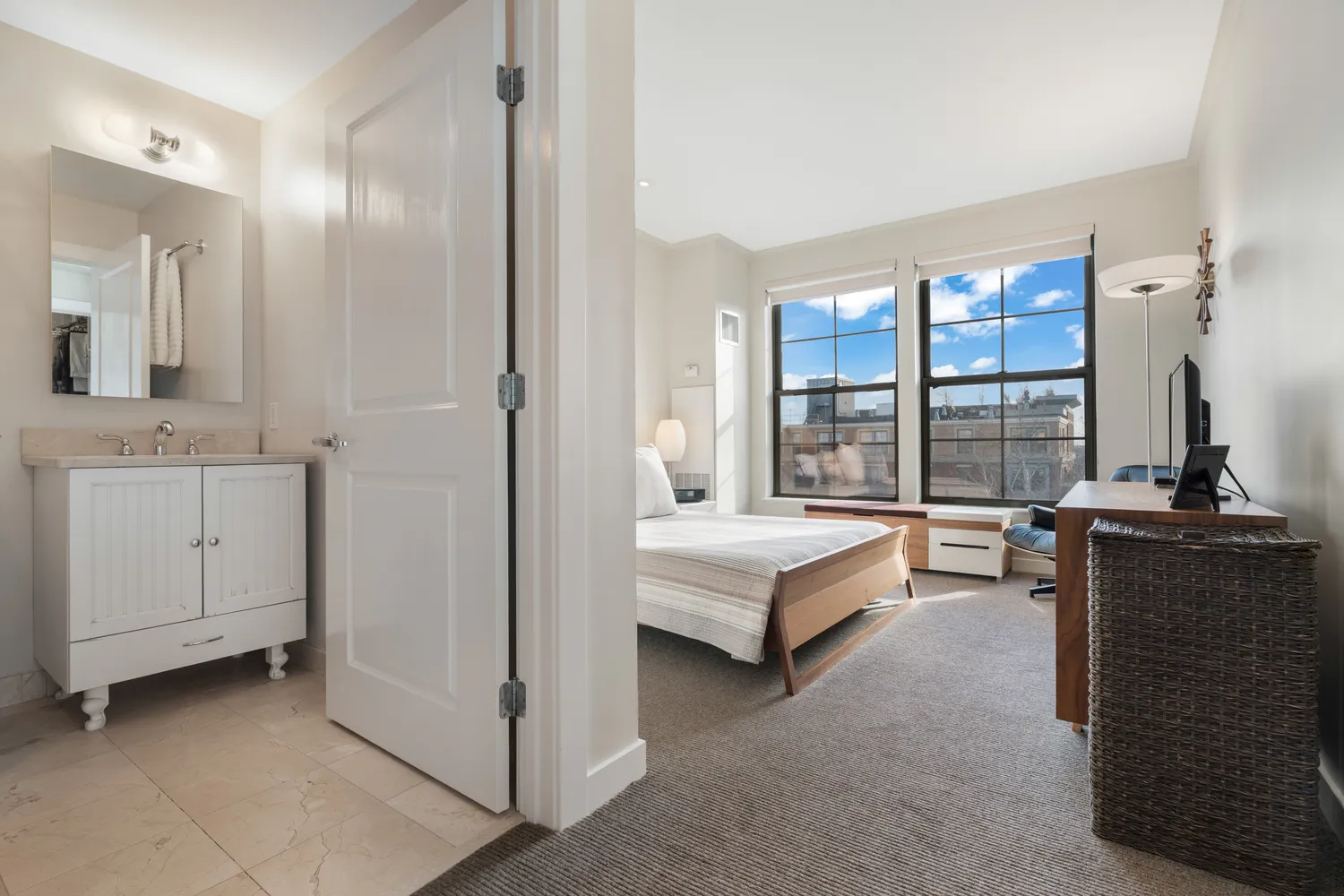 a spacious bedroom with a bed and a dresser