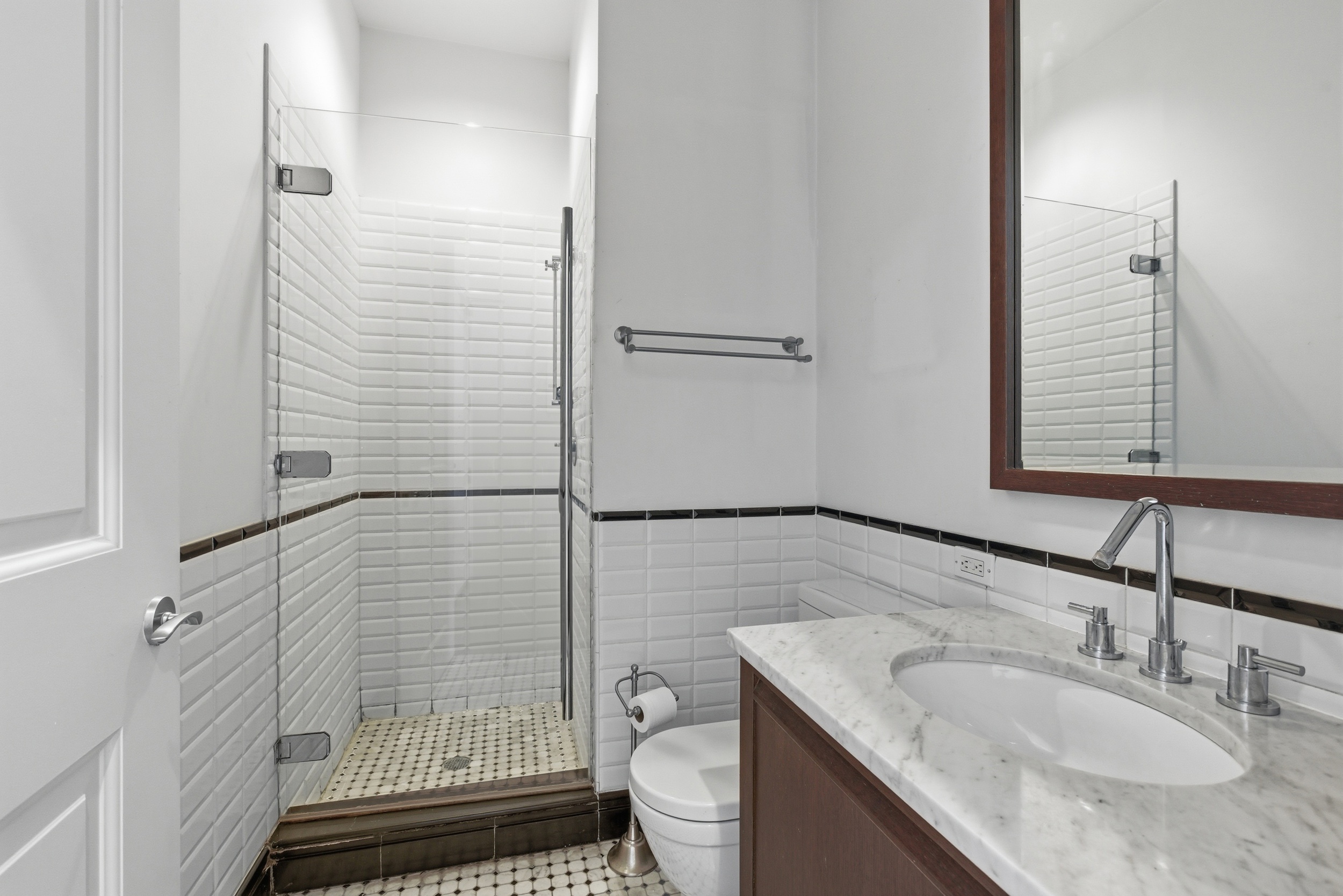 655 6th Avenue, Unit 3D Manhattan, NY 10010 - Photo 16 of 20 a bathroom with a granite countertop sink a toilet and shower
