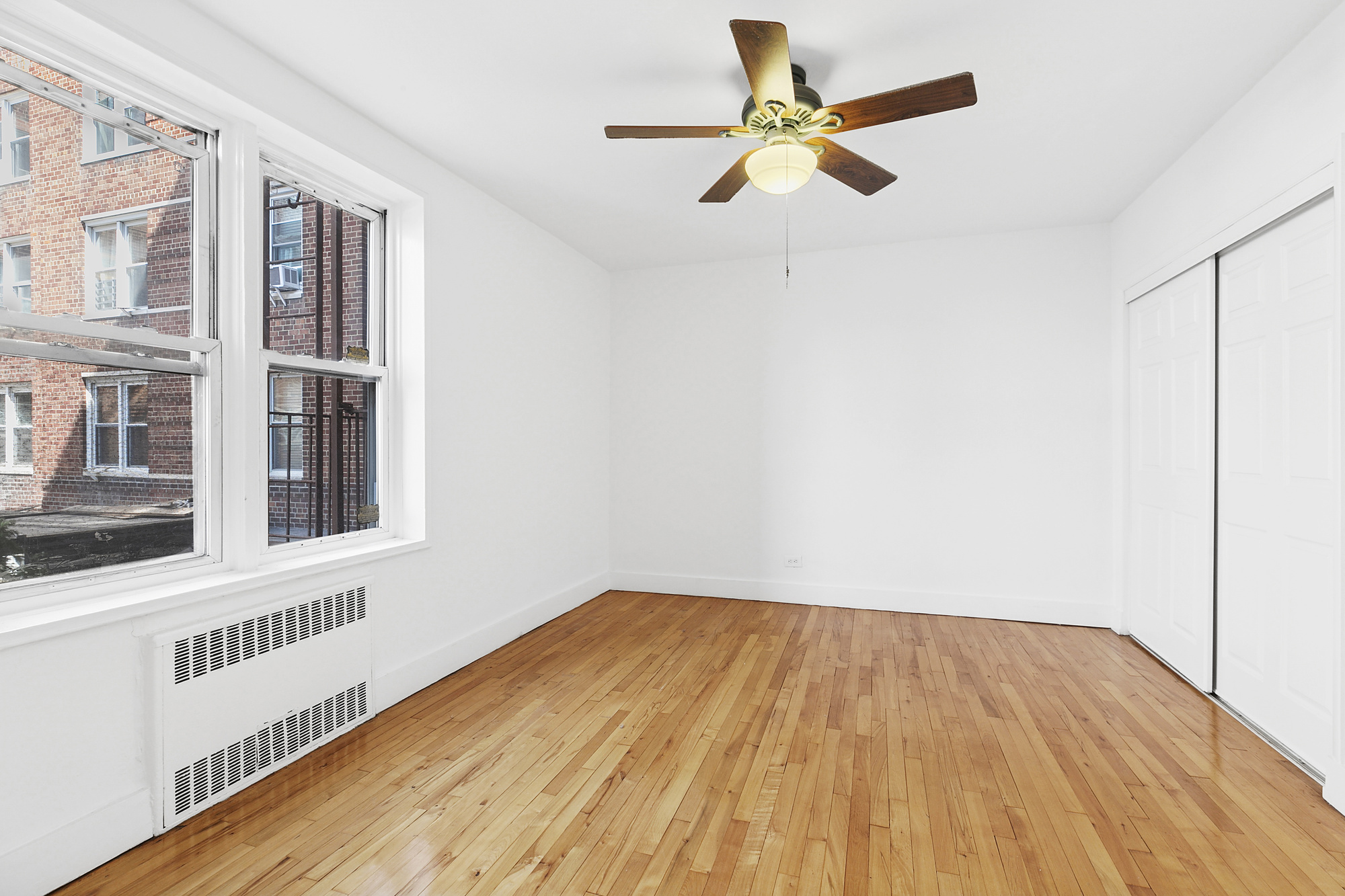 9801 Shore Road, Unit 1K Brooklyn, NY 11209 - Photo 10 of 11 a view of an empty room with wooden floor