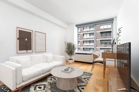 a living room with furniture and a book shelf