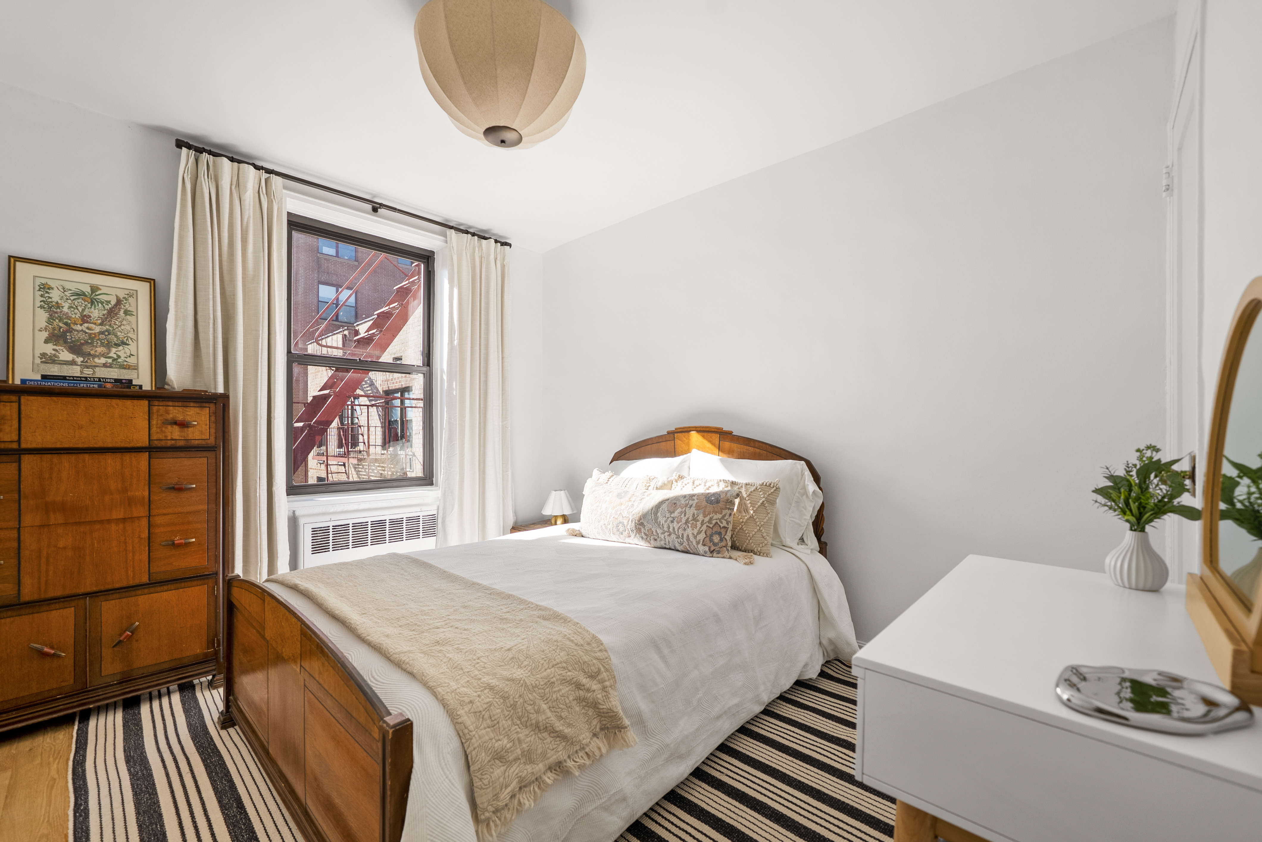 165 Christopher Street, Unit 6DD Manhattan, NY 10014 - Photo 6 of 8 a bedroom with a bed and a painting on the wall