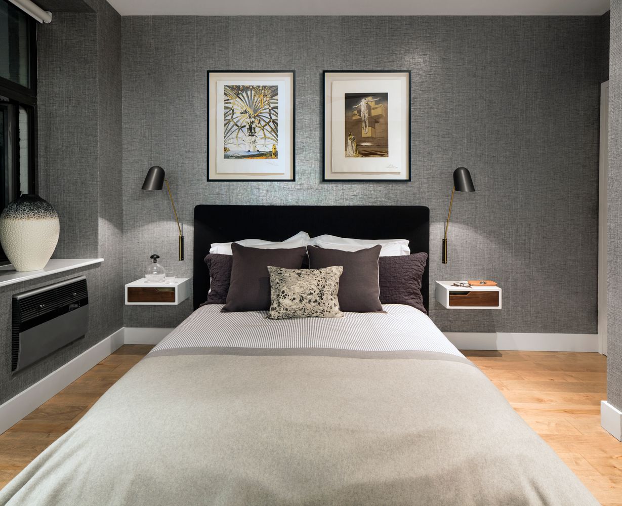 a bedroom with bed and wooden floor