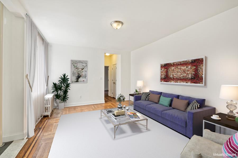 61-09 39th Avenue, Unit 2H Queens, NY 11377 - Photo 2 of 9 a living room with furniture and a potted plant