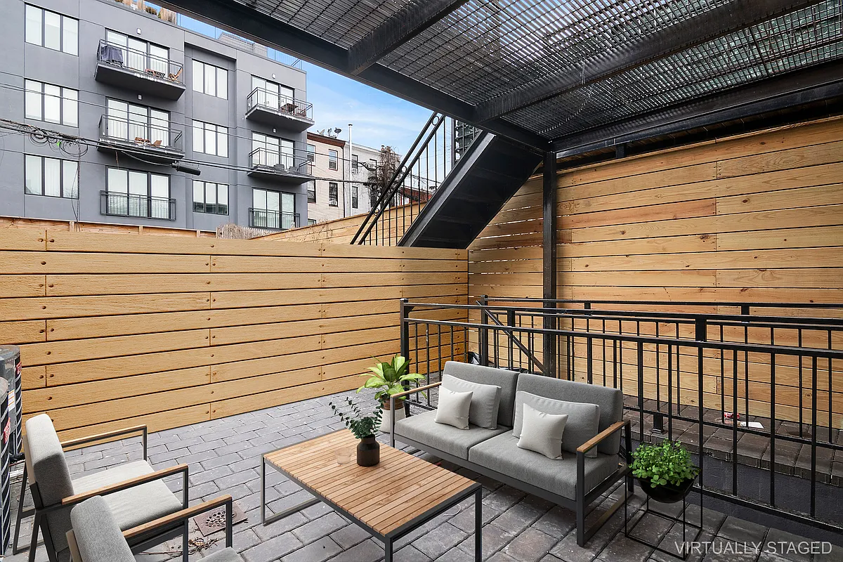 587 Van Buren Street, Unit 1 Brooklyn, NY 11221 - Photo 2 of 8 a view of a patio with couches chairs and wooden floor