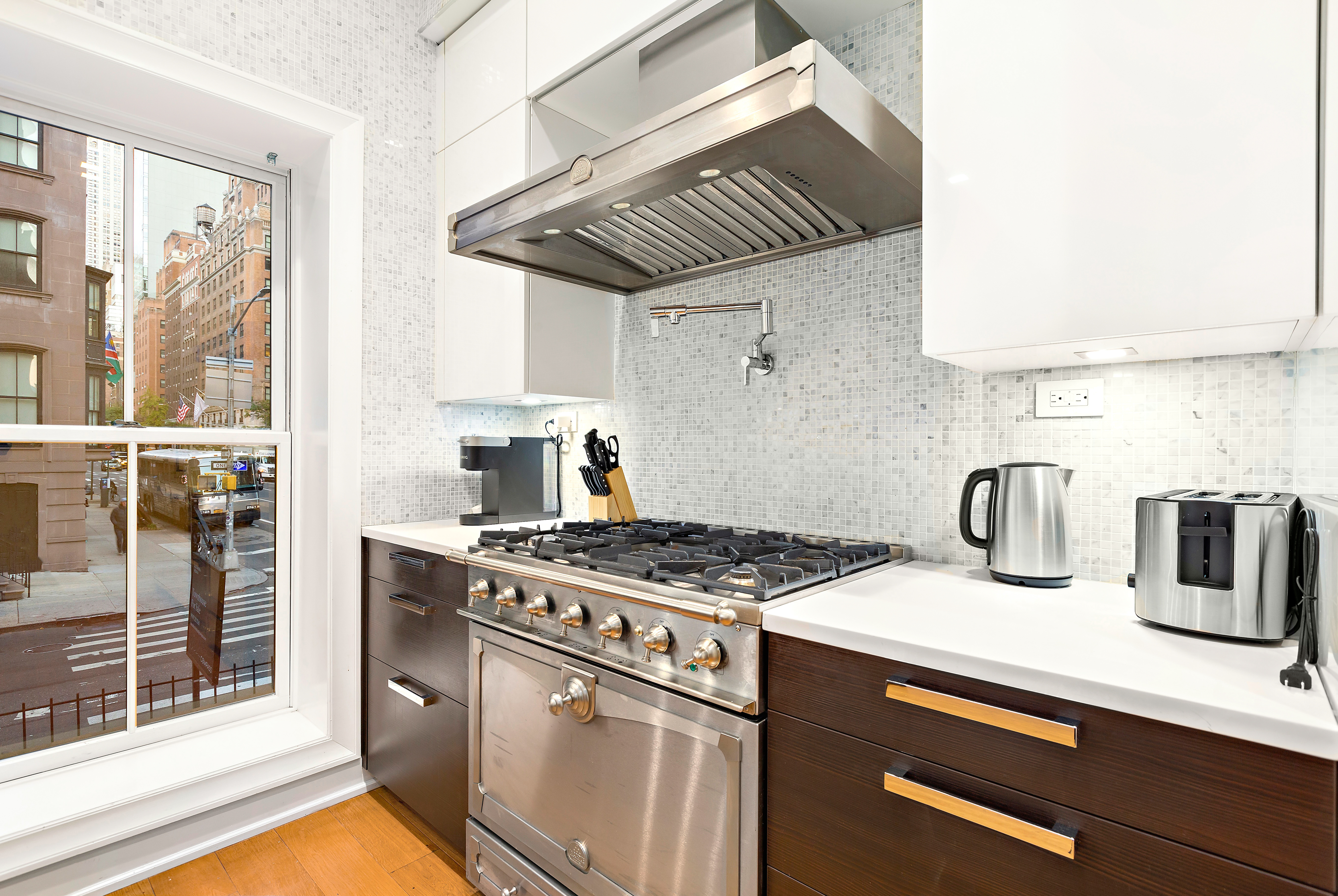 134 East 36th Street Manhattan, NY 10016 - Photo 5 of 28 a kitchen with a stove and a sink
