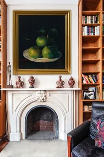 a utility room with fireplace and lots of clutter