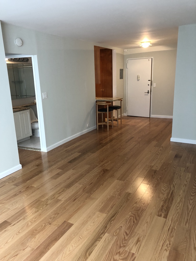 61 West 62nd Street, Unit 7C Manhattan, NY 10023 - Photo 3 of 7 a view of a livingroom with wooden floor and staircase