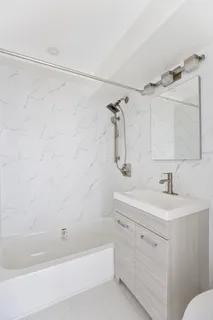 a bathroom with a sink toilet vanity and shower