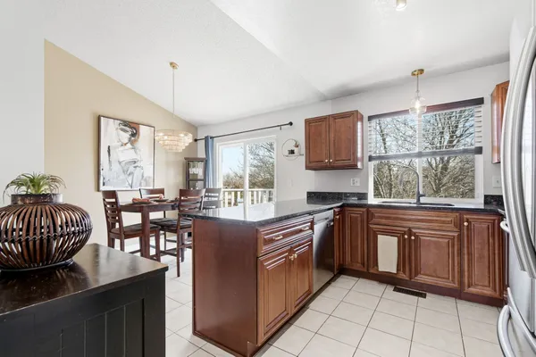 a view of staircase with lots of frames on wall and wooden floor