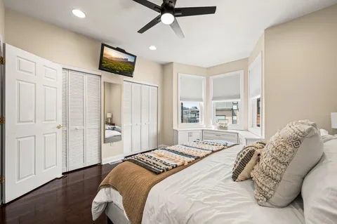 a bedroom with a bed and a flat screen tv