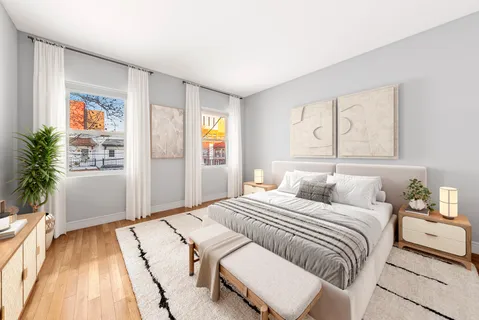 a bedroom with a bed and a potted plant