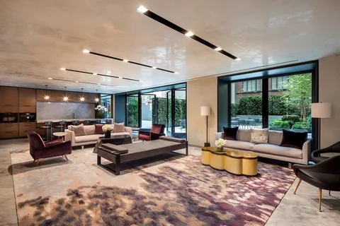 a living room with furniture and large windows