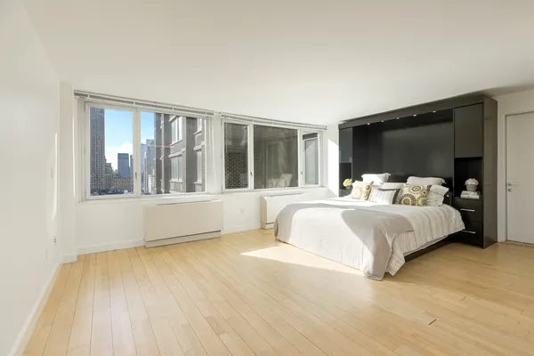 a bedroom with a large bed and a large window