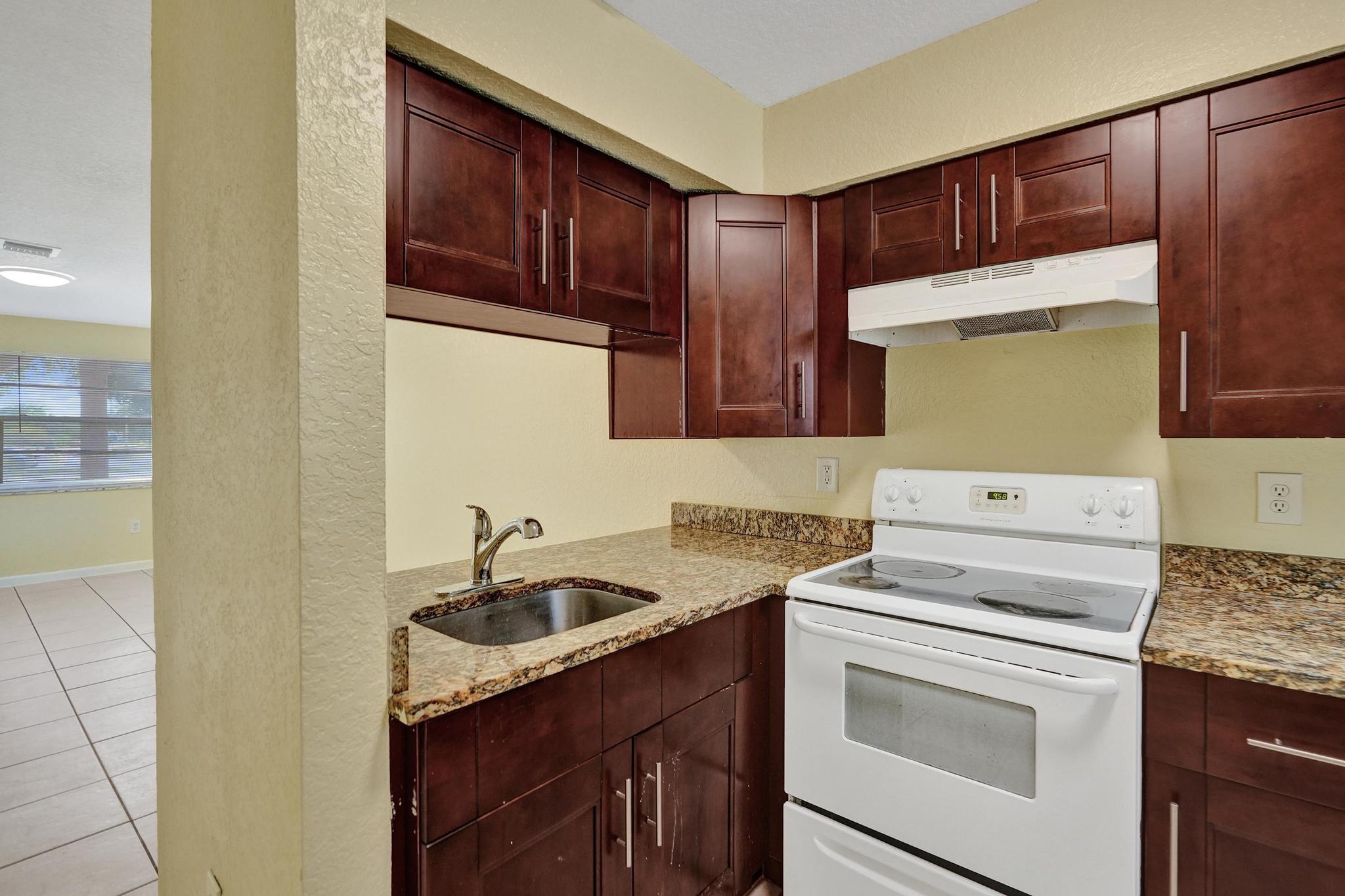 1101 Prospect Road Fort Lauderdale, FL 33309 - Photo 29 of 34 a kitchen with a sink stove and cabinets