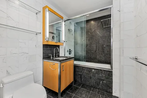 a bathroom with a toilet a sink and shower