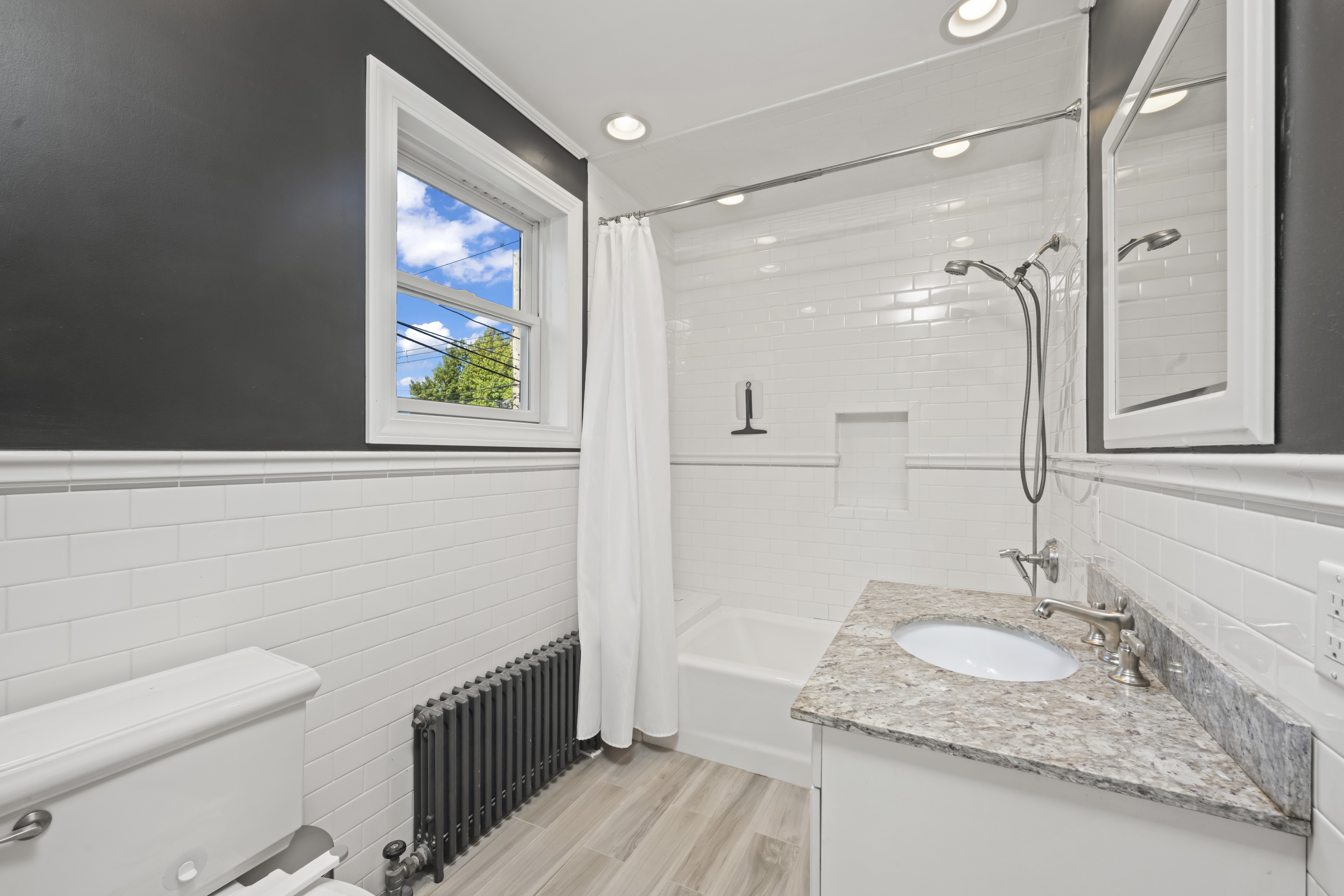 704 Delafield Avenue Staten Island, NY 10310 - Photo 11 of 35 a bathroom with a granite countertop sink a mirror and a shower