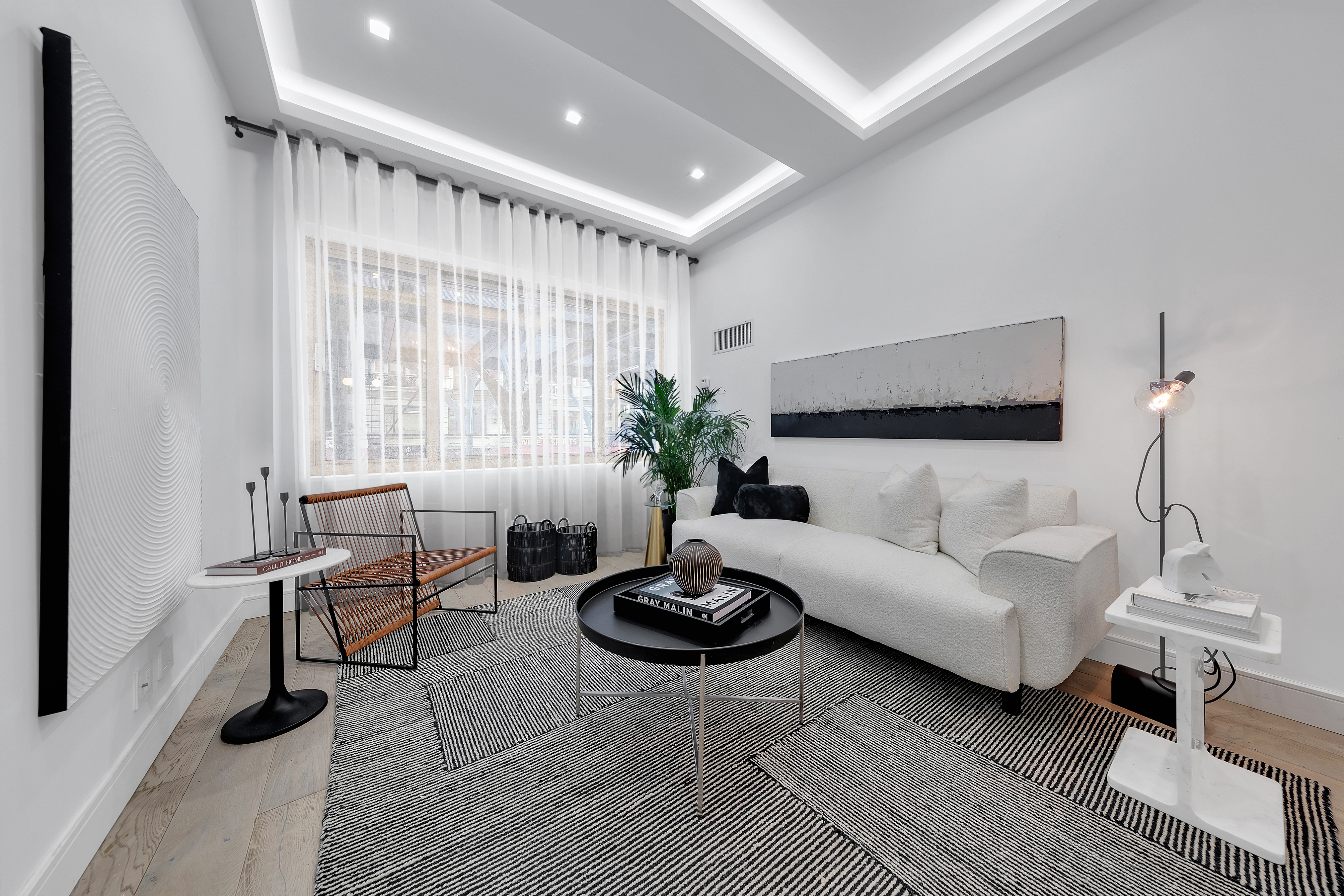 106 Central Park South, Unit 2B Manhattan, NY 10019 - Photo 2 of 12 a living room with furniture a lamp and a potted plant