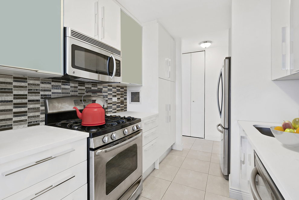 112-01 Queens Boulevard, Unit 8B Queens, NY 11375 - Photo 4 of 19 a kitchen with a stove and a microwave