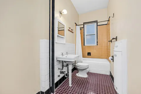 a bathroom with a sink a toilet and a shower