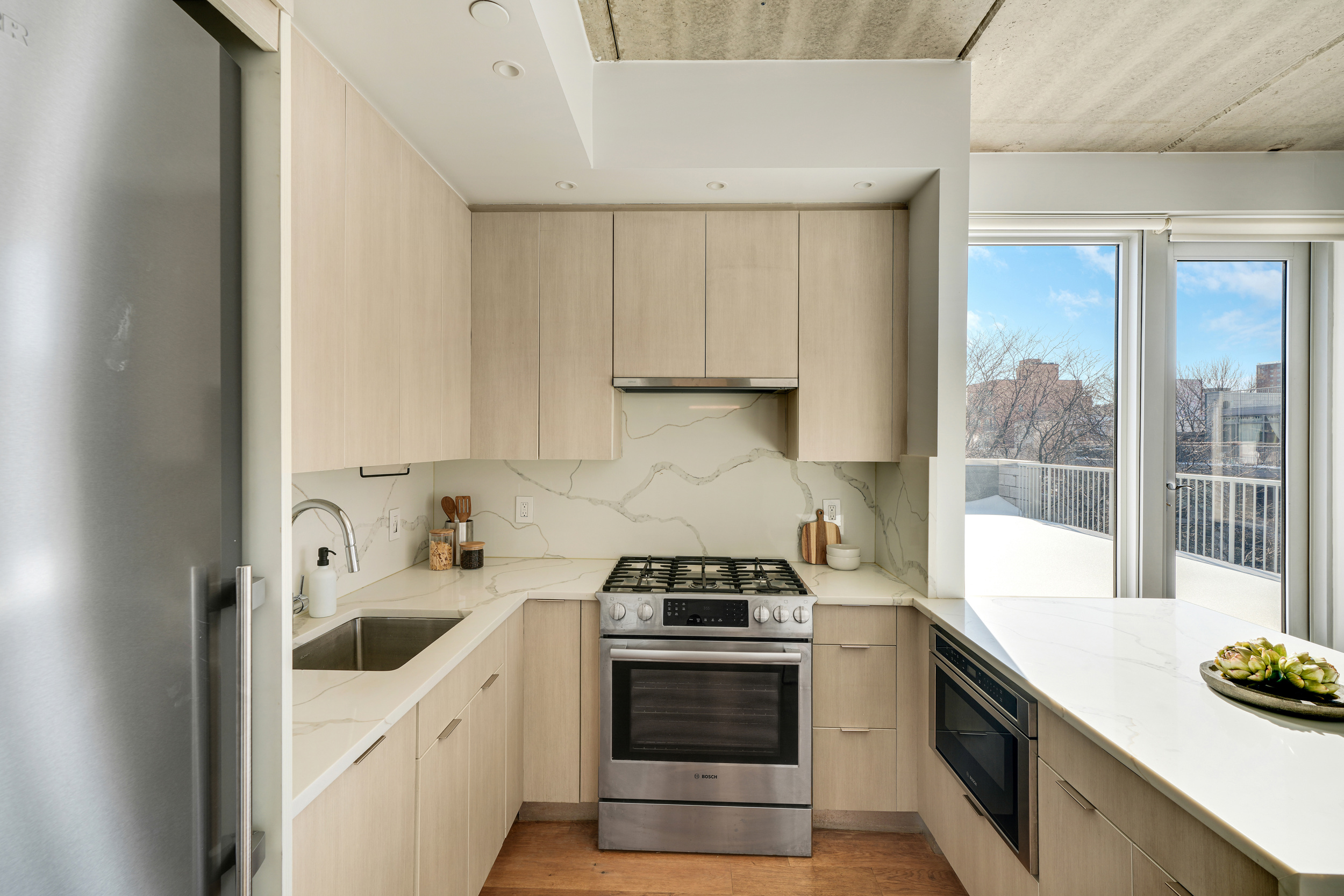 175 Spencer Street, Unit 6B Brooklyn, NY 11205 - Photo 4 of 15 a kitchen with a sink and a stove top oven