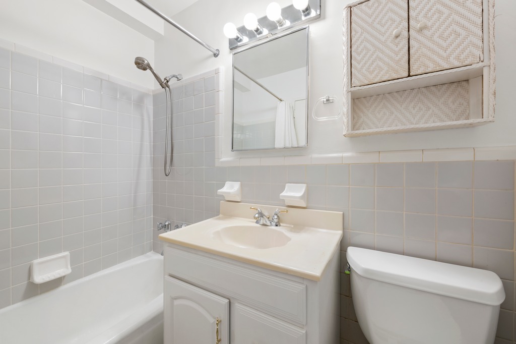 123 East 75th Street, Unit 6A Manhattan, NY 10021 - Photo 6 of 9 a bathroom with a sink a toilet and shower