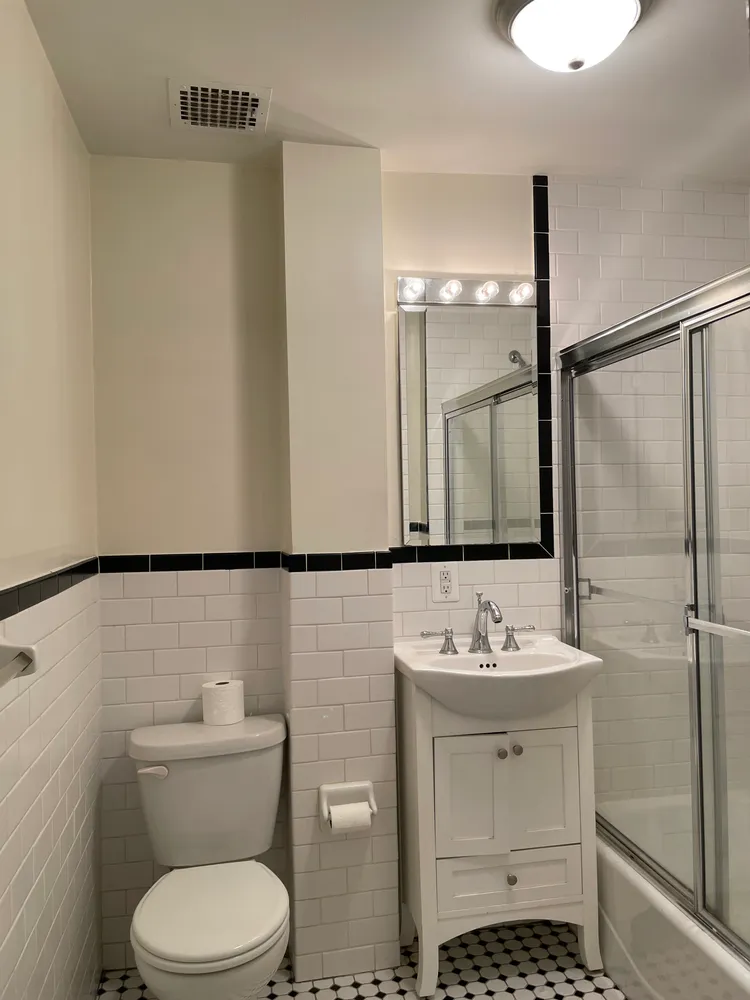 a bathroom with a sink toilet and shower