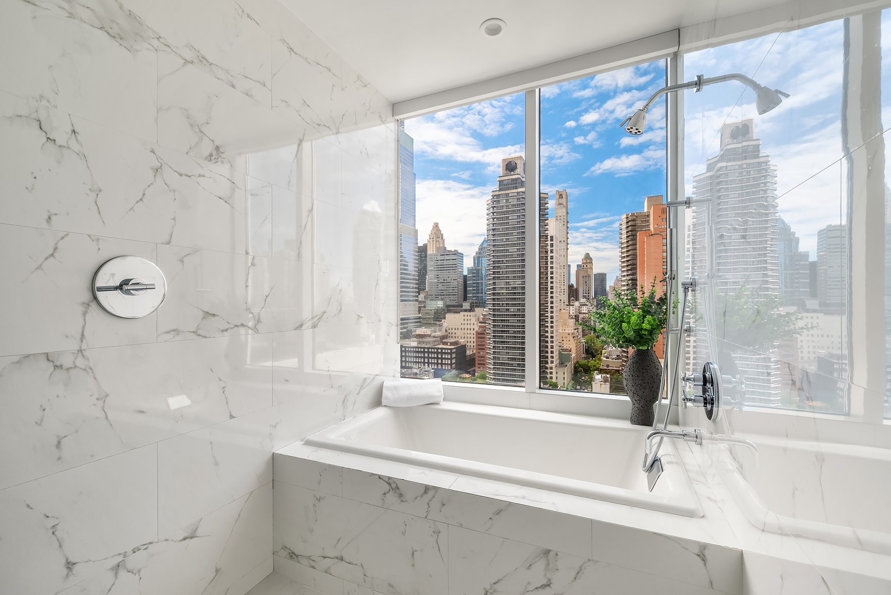 301 East 61st Street, Unit 17A Manhattan, NY 10065 - Photo 8 of 16 a bathroom with a shower and a bathtub