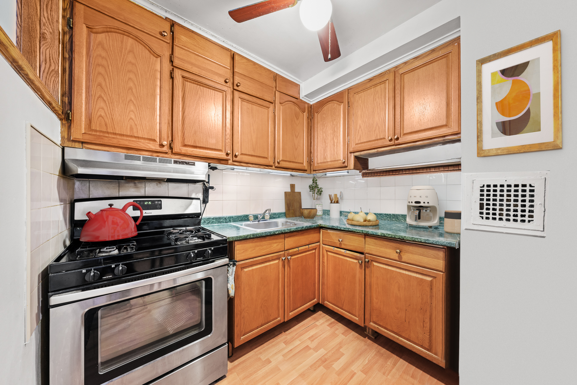 495 East 7th Street, Unit 7D Brooklyn, NY 11218 - Photo 4 of 10 a kitchen with stainless steel appliances granite countertop a stove and a microwave