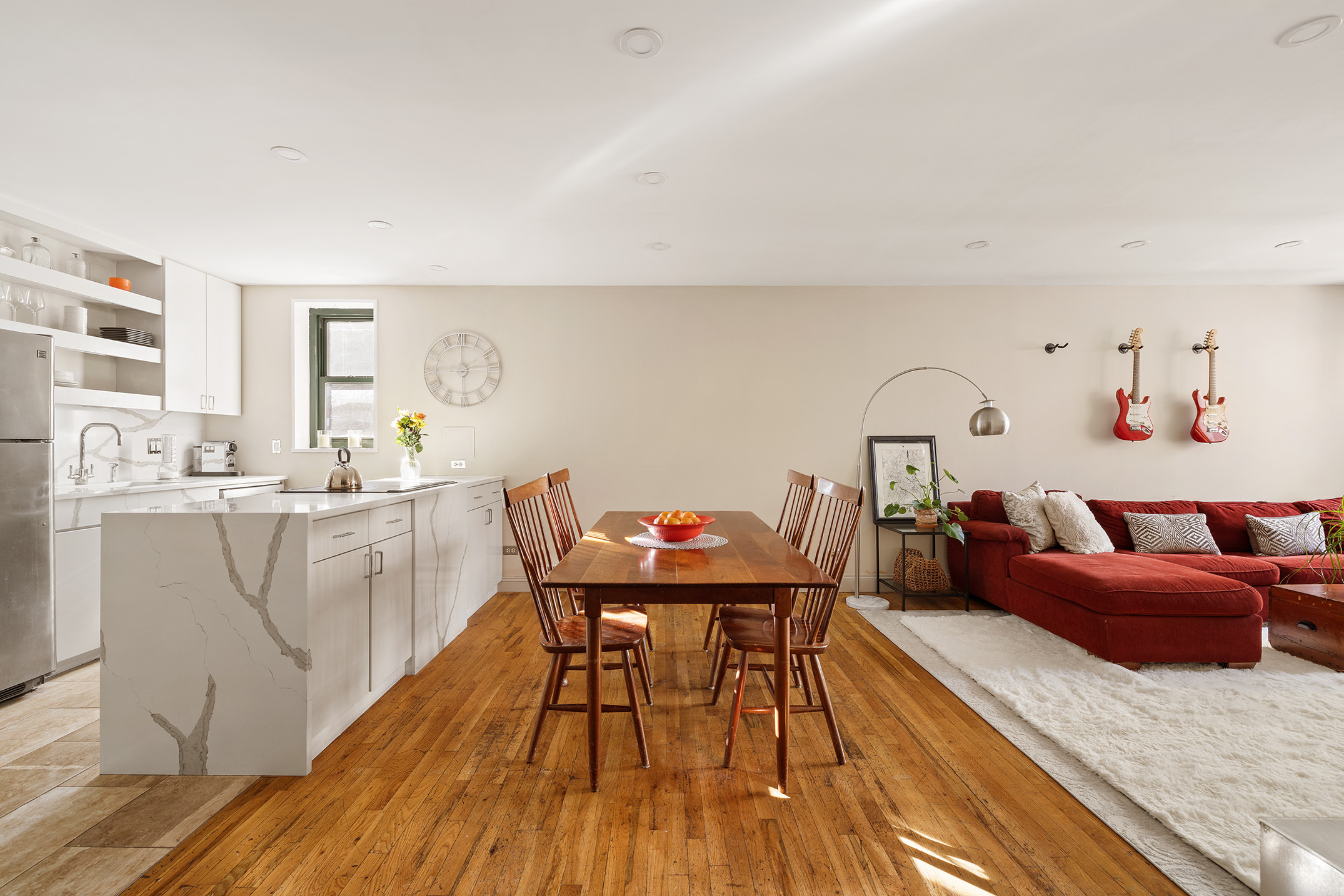 a living room with furniture and wooden floor