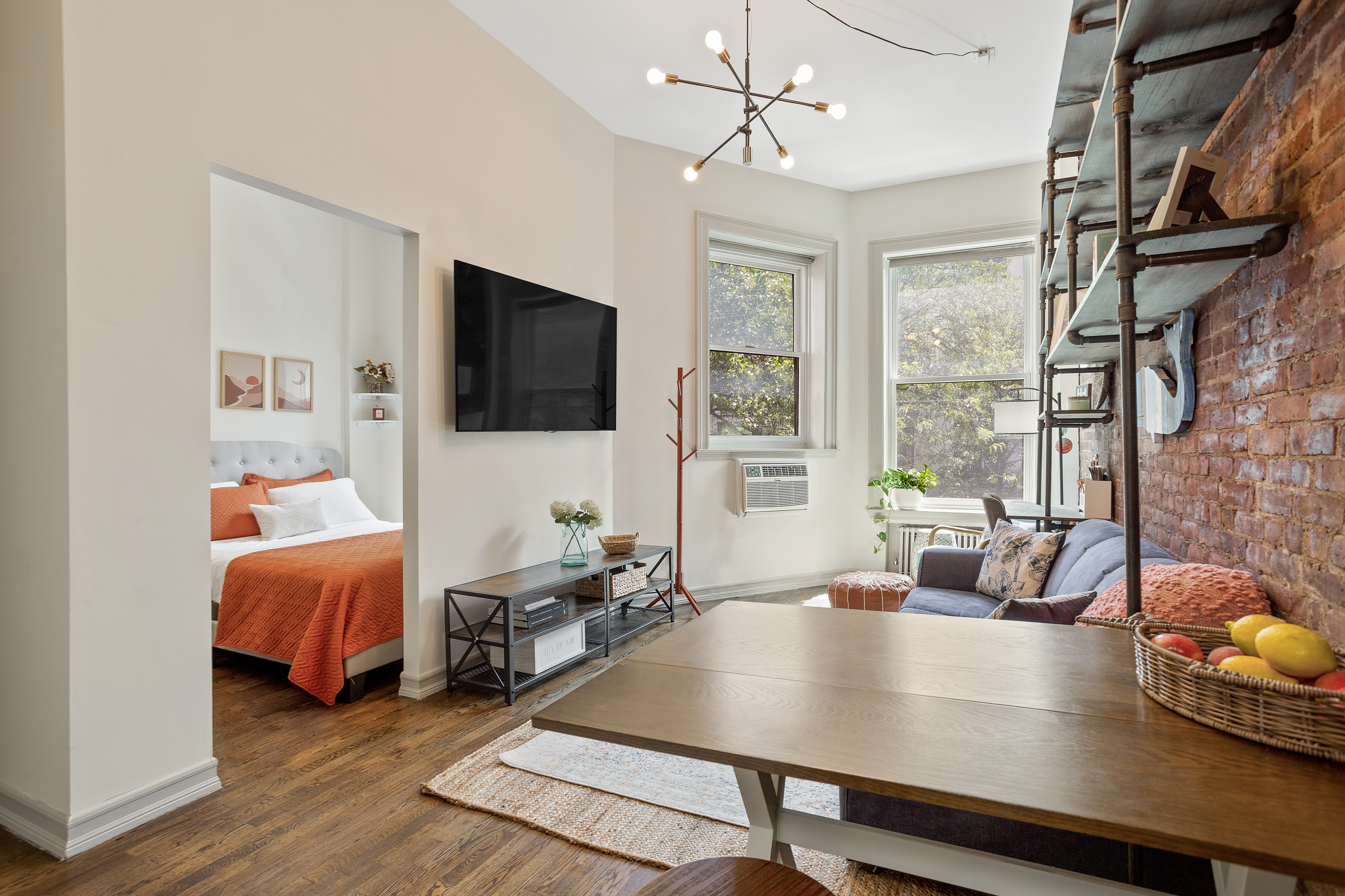 55 West 84th Street, Unit 5 Manhattan, NY 10024 - Photo 2 of 8 a living room with furniture and a flat screen tv
