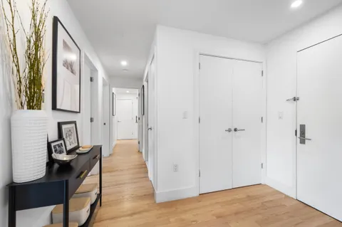 a view of a hallway with wooden floor