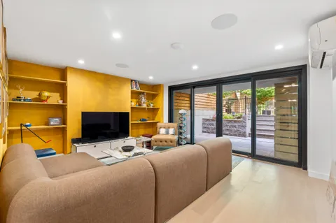 a view of a livingroom with furniture and a flat screen tv