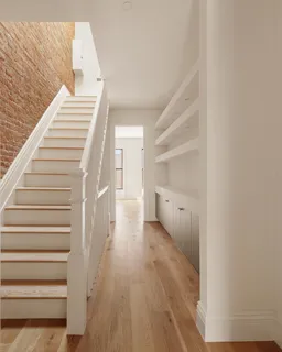 a bathroom with a double vanity sink a large mirror and a bathtub