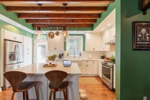a kitchen with stainless steel appliances granite countertop a stove and a refrigerator
