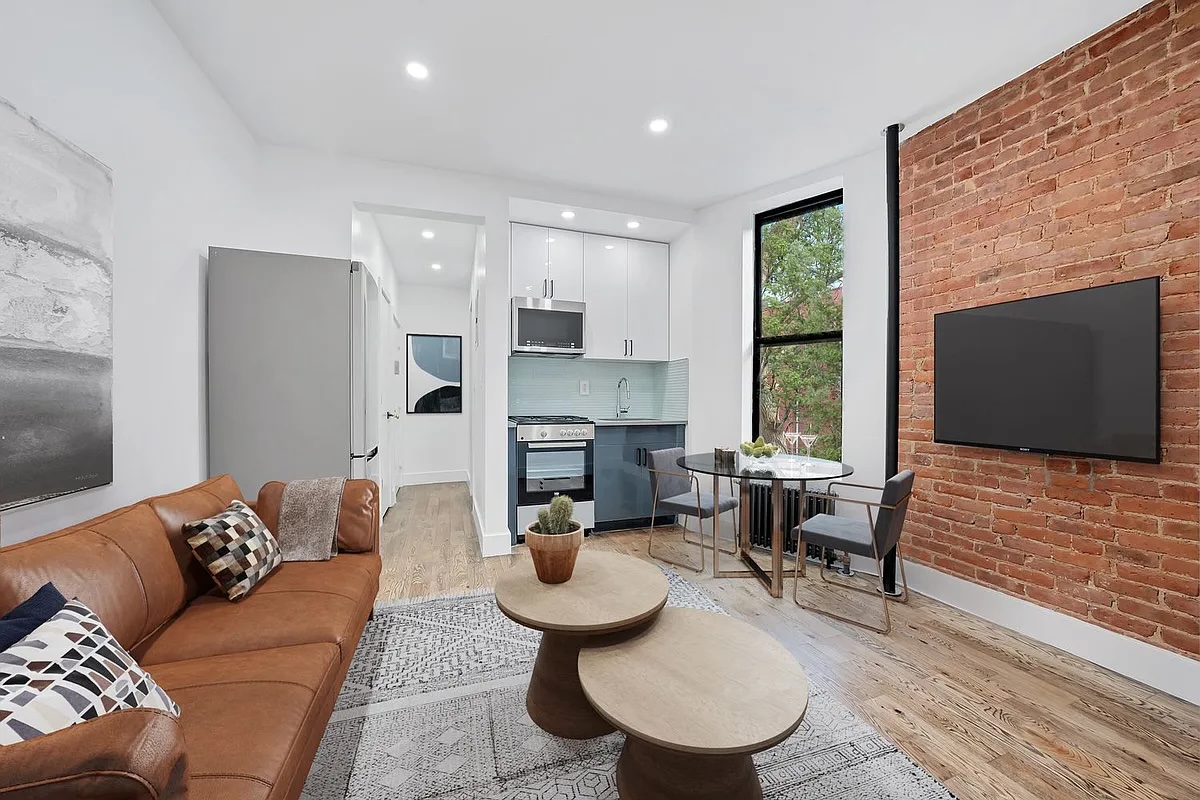 66 West 138th Street, Unit 2C Manhattan, NY 10037 - Photo 2 of 5 a living room with fireplace furniture and a flat screen tv