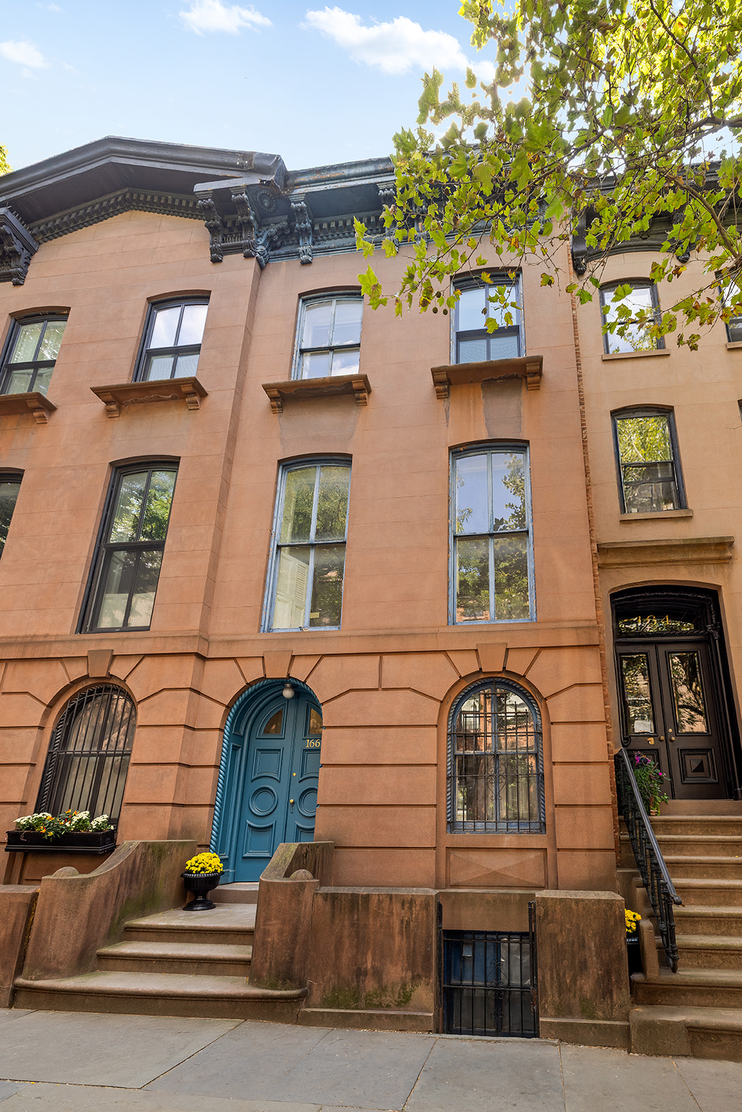 166 Congress Street, Unit A Brooklyn, NY 11201 - Photo 8 of 9 a front view of a residential apartment building with a yard