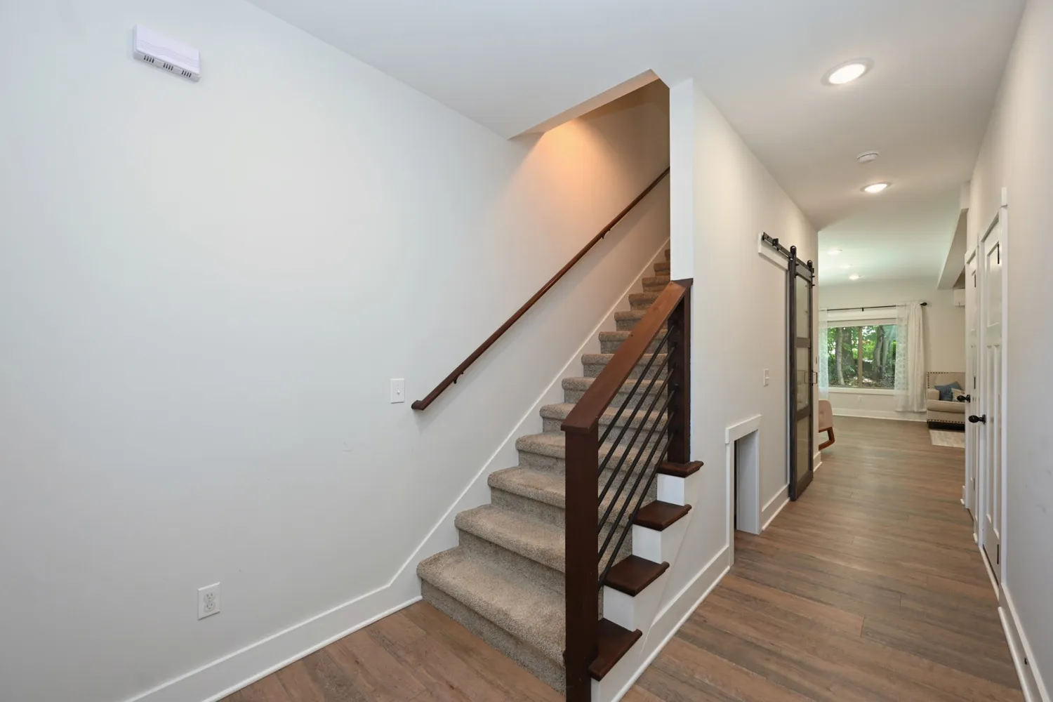 a view of entryway with wooden floor and stairs
