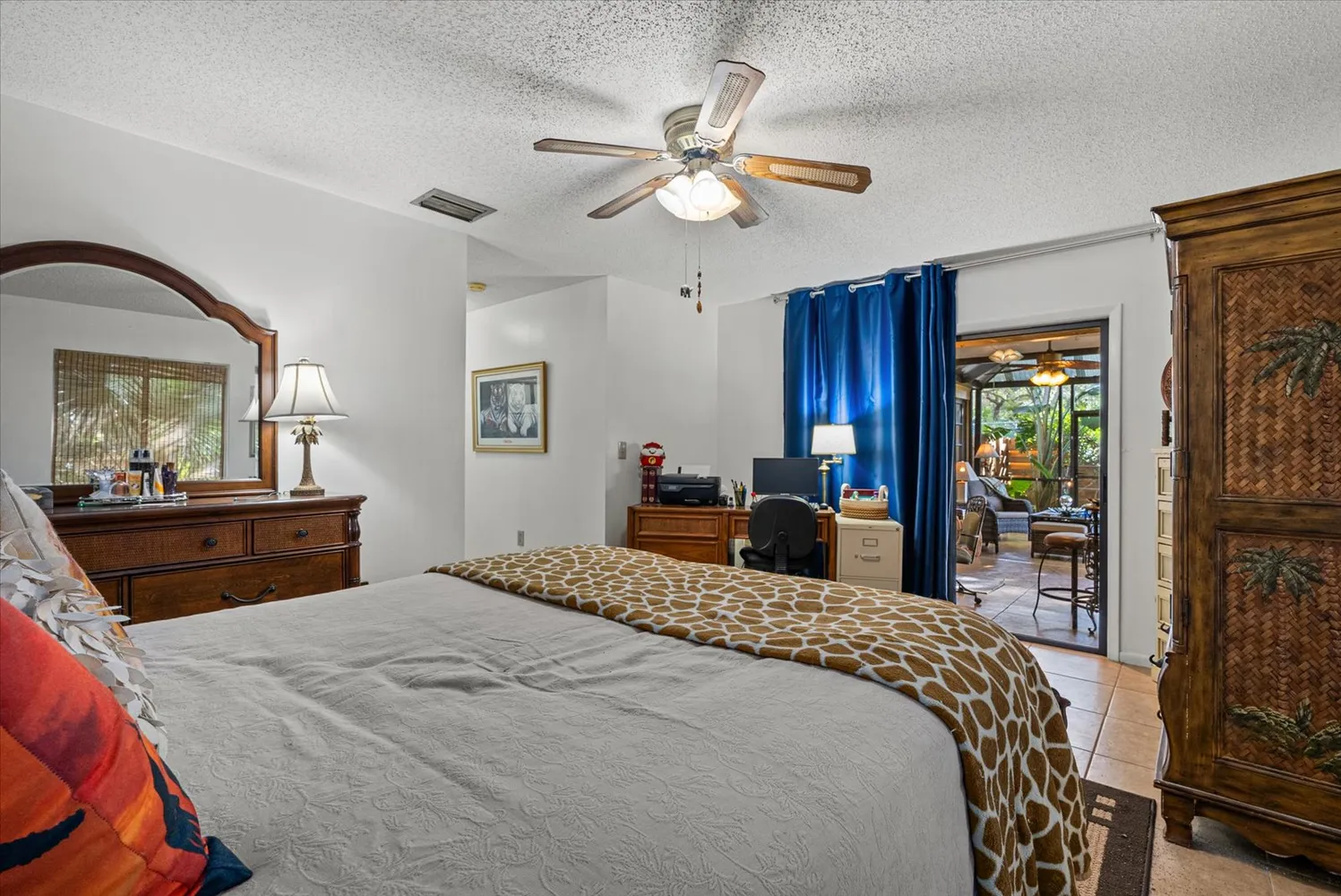 a bedroom with a bed dresser and a large window
