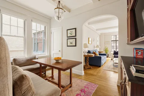 a living room with furniture a wooden floor and a window