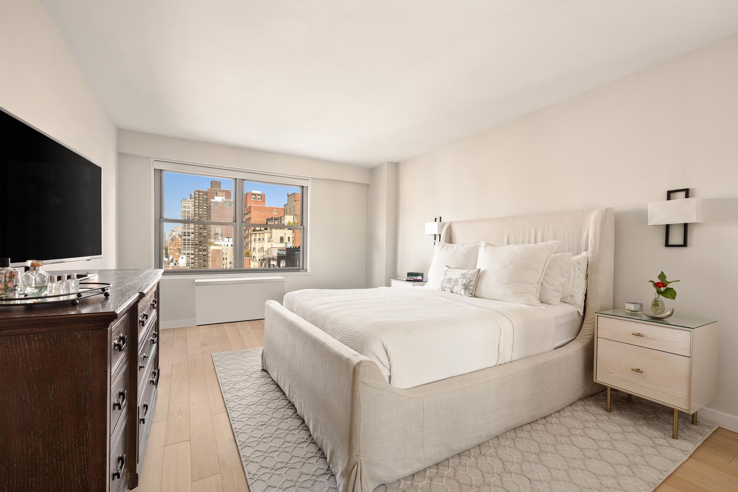 a bedroom with a large bed and a flat screen tv