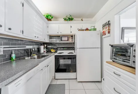 a kitchen with stainless steel appliances and white cabinets