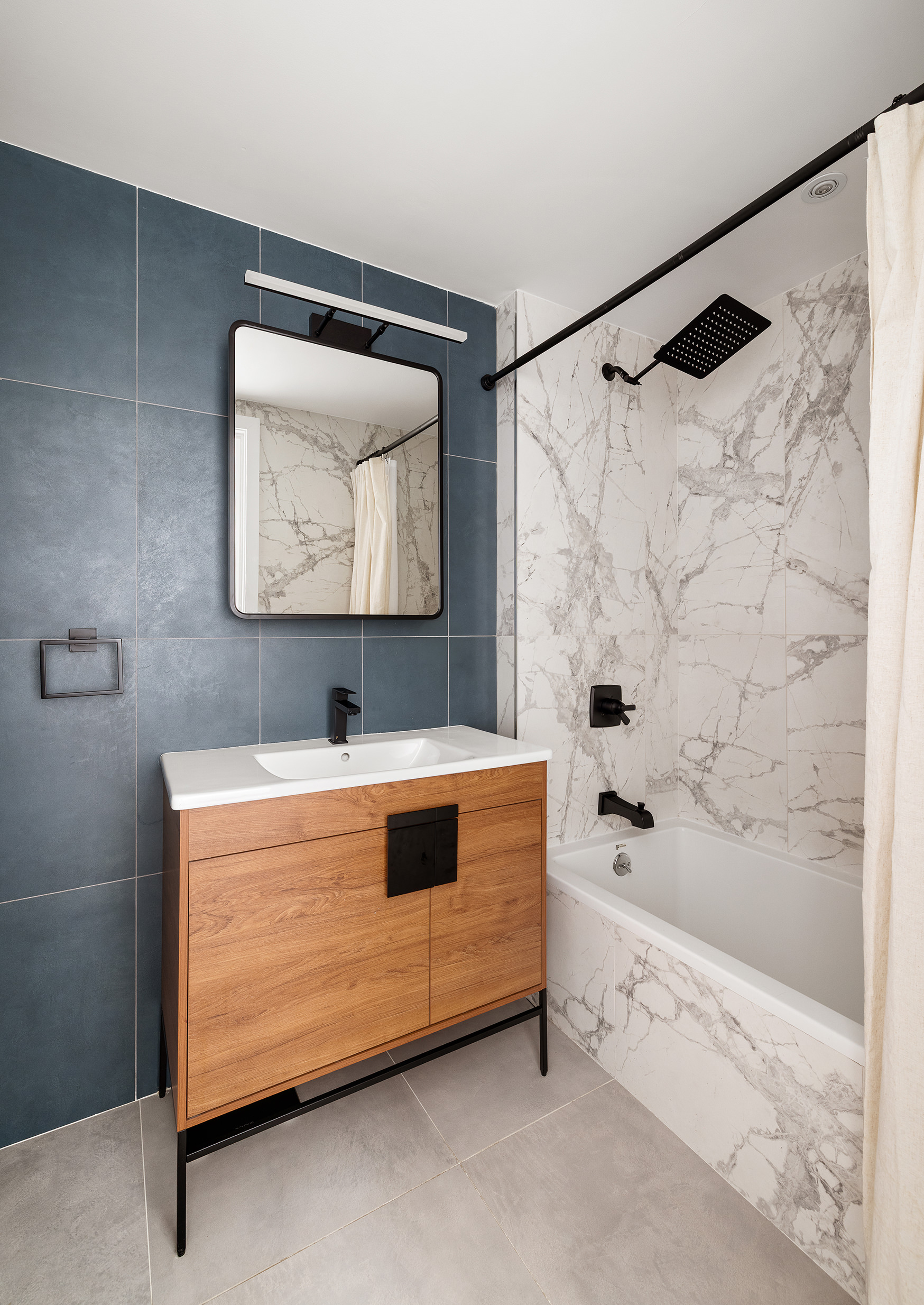 109 Waverly Avenue, Unit 4B Brooklyn, NY 11205 - Photo 7 of 14 a bathroom with a tub a sink and a shower