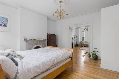 a bedroom with a bed and a chandelier
